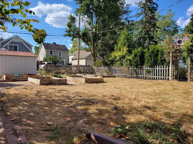 859 Gladden Rd, Grandview Heights, OH 43212 - view of yard with a vegetable garden, a storage shed, and an outbuilding