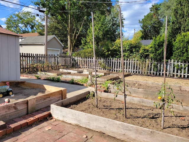 859 Gladden Rd, Grandview Heights, OH 43212 - view of yard with a vegetable garden, an outbuilding, fence, and a garage