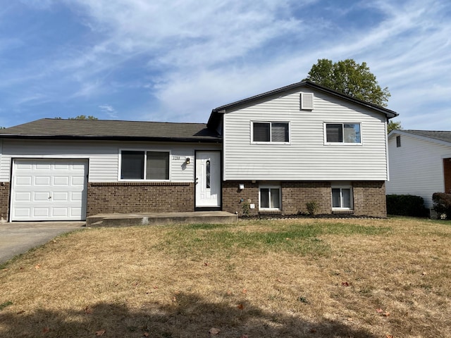 tri-level home featuring a front yard and a garage