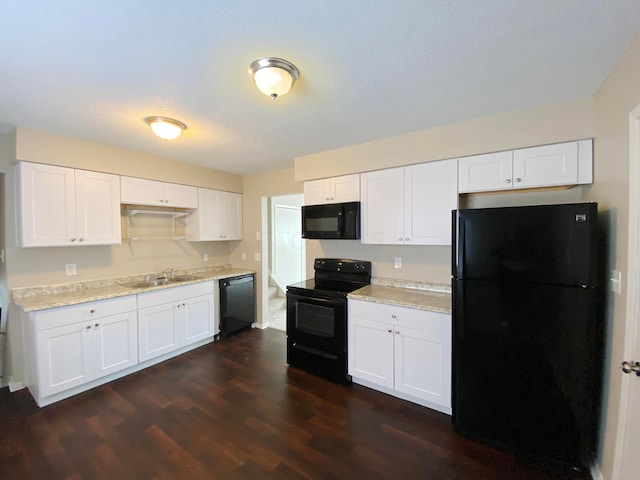 kitchen featuring sink, white cabinetry, black appliances, and dark wood-type flooring