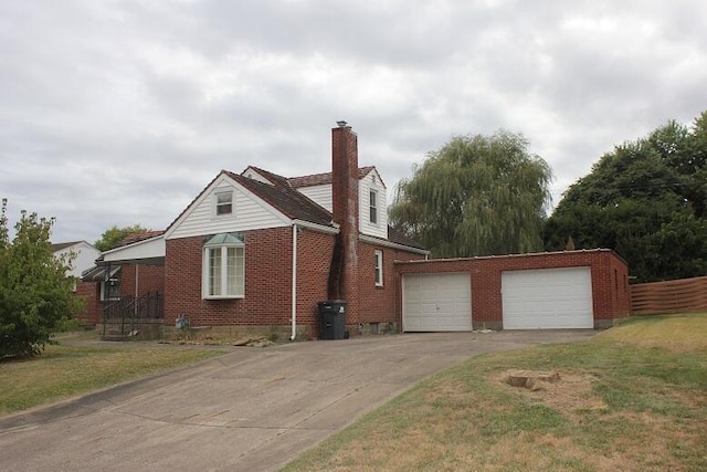 view of home's exterior with a lawn, an outbuilding, and a garage