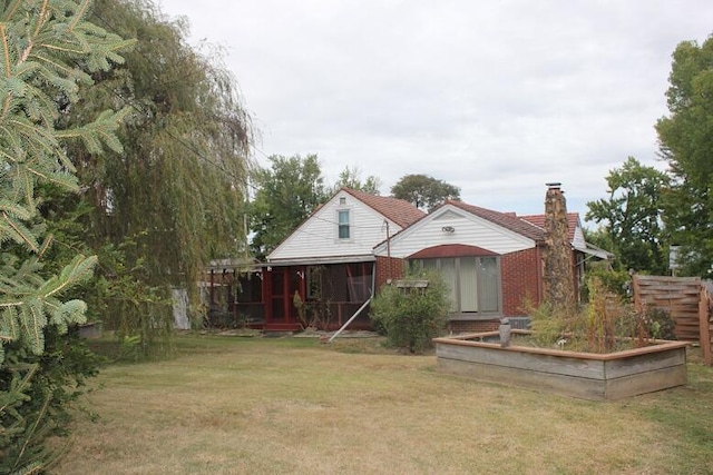 back of house with a yard