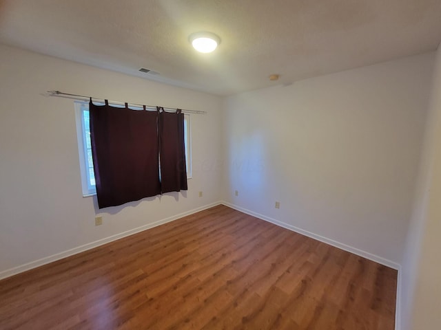 spare room featuring hardwood / wood-style flooring