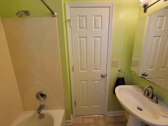 bathroom featuring sink,  shower combination, and tile patterned flooring