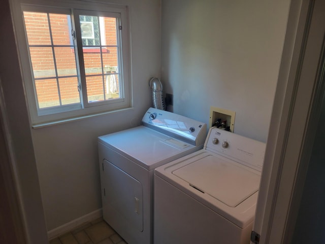 laundry room featuring washer and clothes dryer and tile patterned flooring