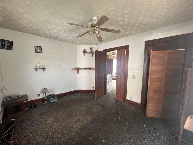 spare room featuring a textured ceiling and ceiling fan