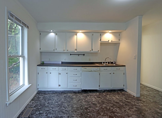 kitchen featuring white cabinets, white dishwasher, a wealth of natural light, and sink