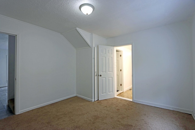 bonus room with carpet floors and a textured ceiling