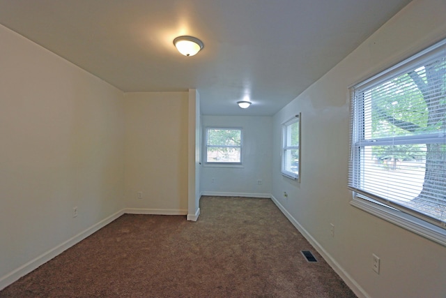 carpeted empty room featuring a healthy amount of sunlight