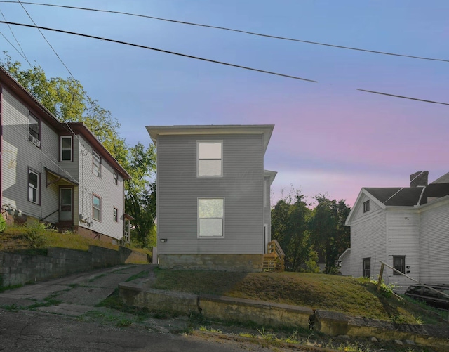 view of back house at dusk