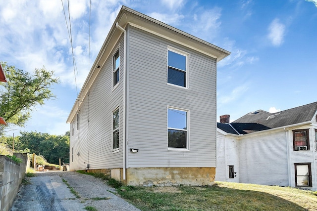 view of property exterior featuring a lawn