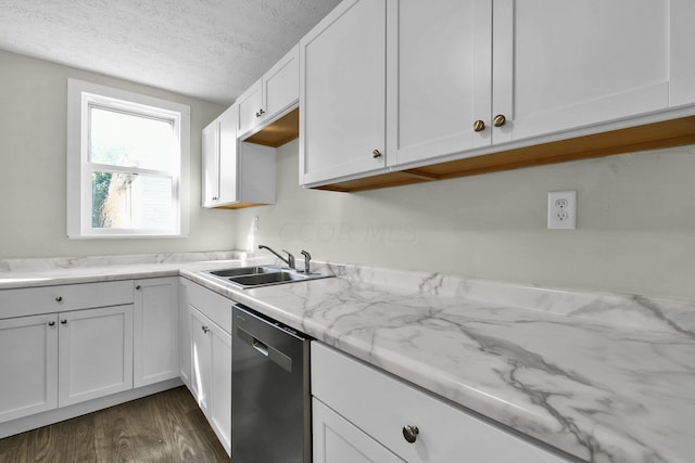 kitchen featuring dark wood-type flooring, white cabinets, sink, stainless steel dishwasher, and a textured ceiling