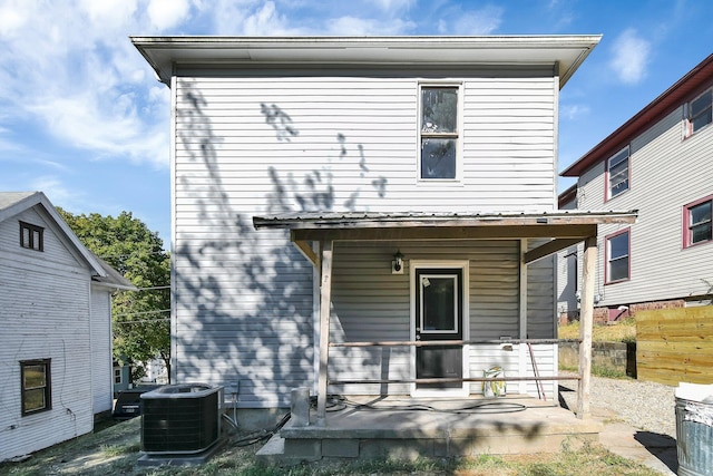 rear view of property with central air condition unit and a porch