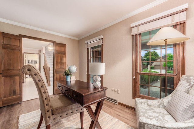 office space featuring light hardwood / wood-style floors and crown molding