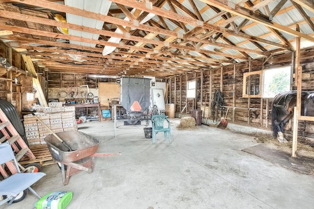 miscellaneous room featuring a workshop area and concrete flooring