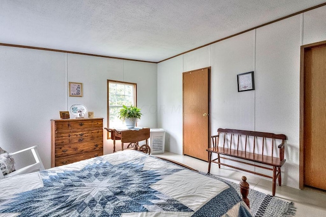 bedroom featuring crown molding and a textured ceiling