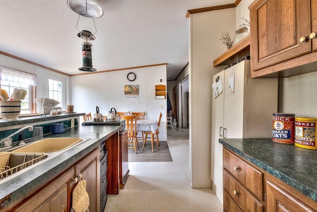 kitchen featuring ornamental molding and sink