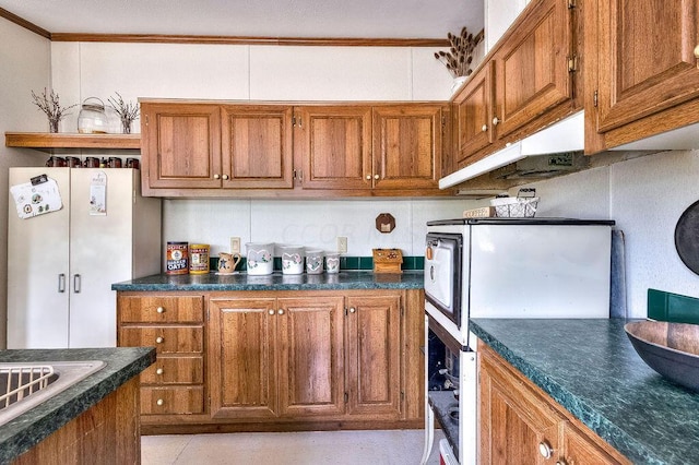 kitchen featuring white fridge and ornamental molding