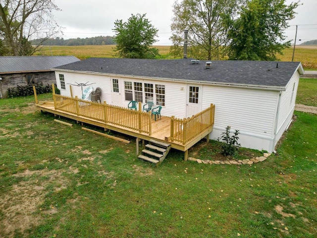 back of property with a lawn and a wooden deck