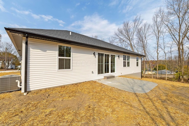 rear view of house featuring central AC unit and a patio