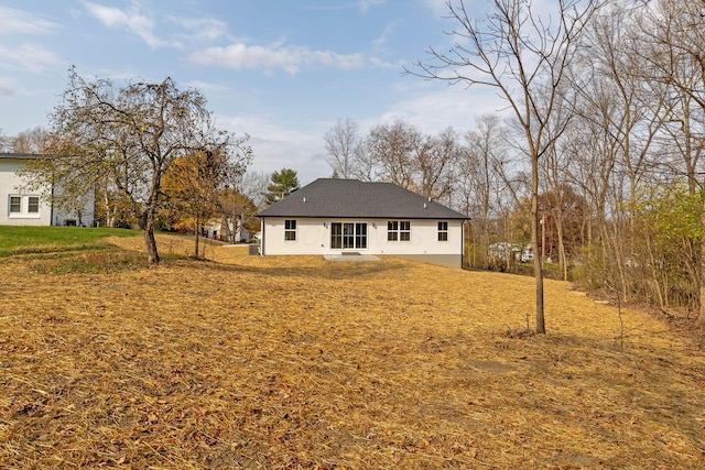 rear view of property with a lawn