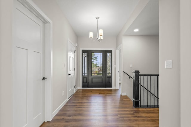 foyer featuring dark hardwood / wood-style flooring and a notable chandelier