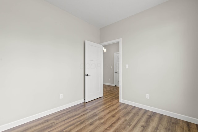 empty room with hardwood / wood-style flooring