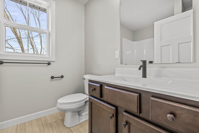 bathroom with vanity, walk in shower, and toilet