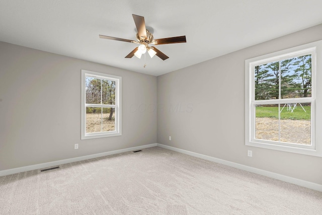 empty room featuring ceiling fan and carpet flooring