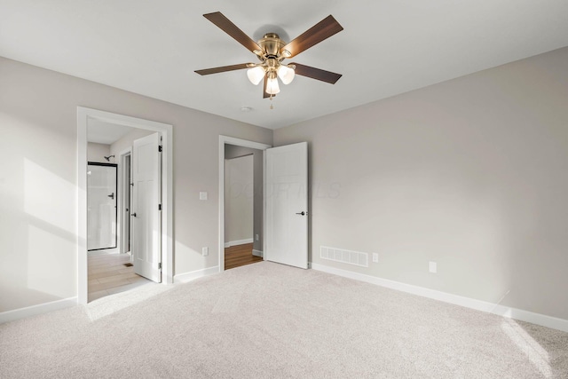 unfurnished bedroom with ceiling fan and light colored carpet