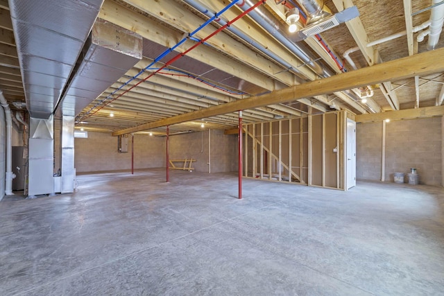 basement featuring heating unit and electric panel