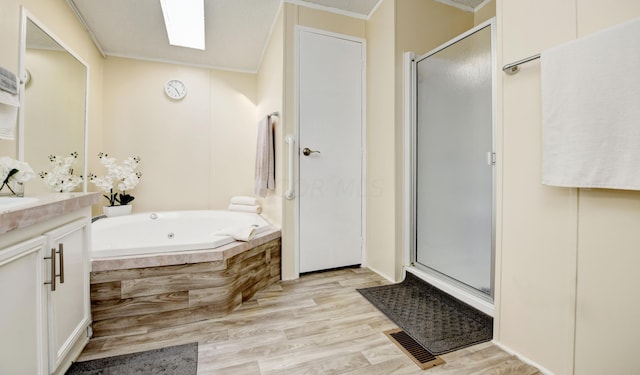 bathroom with separate shower and tub, crown molding, hardwood / wood-style floors, and vanity