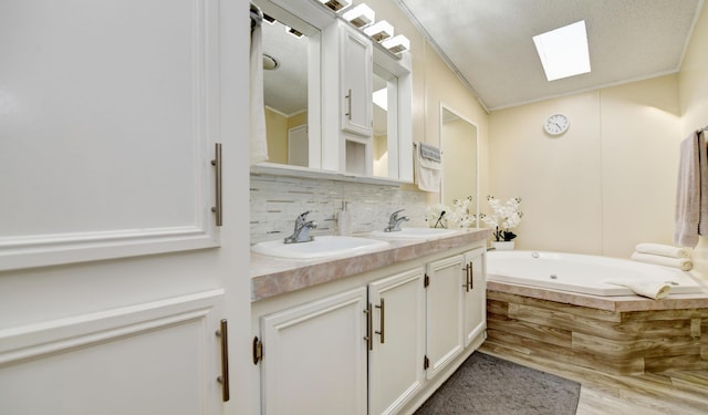 bathroom with a washtub, tasteful backsplash, crown molding, and a skylight