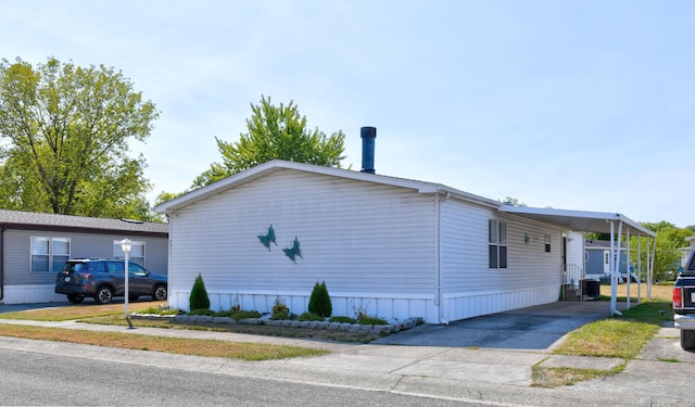 view of side of home with a carport