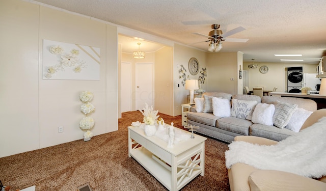 living room with carpet flooring, a textured ceiling, ceiling fan, and stacked washer / drying machine