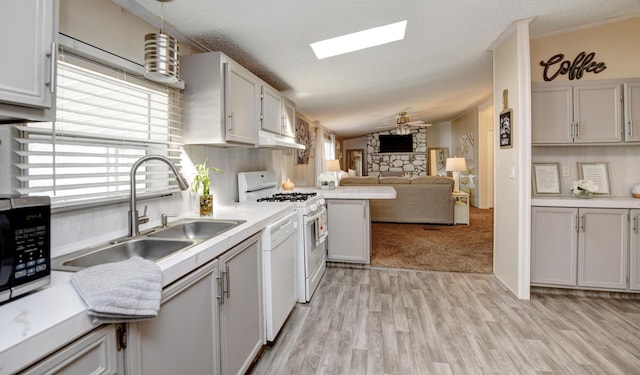 kitchen featuring pendant lighting, white cabinetry, and vaulted ceiling