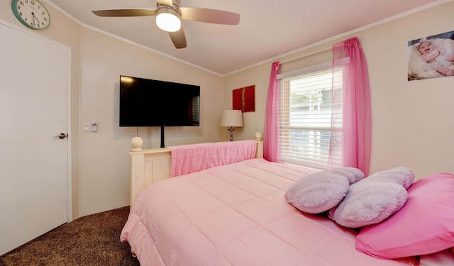 carpeted bedroom with ceiling fan, vaulted ceiling, and ornamental molding