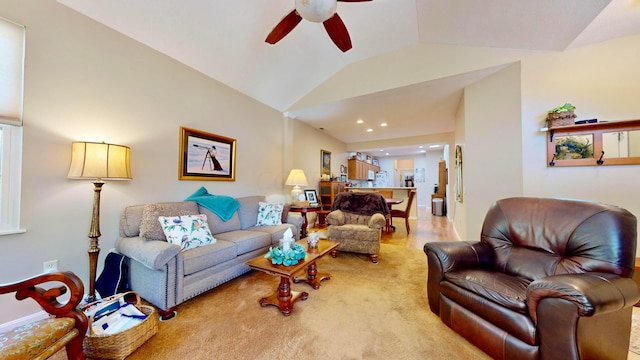 carpeted living room featuring vaulted ceiling and ceiling fan