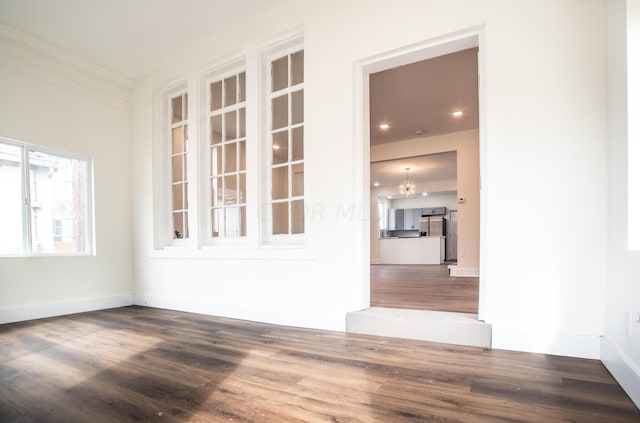 1280 E Mound St, Columbus, OH 43205 - spare room featuring hardwood / wood-style floors and an inviting chandelier
