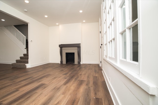 unfurnished living room featuring dark hardwood / wood-style flooring