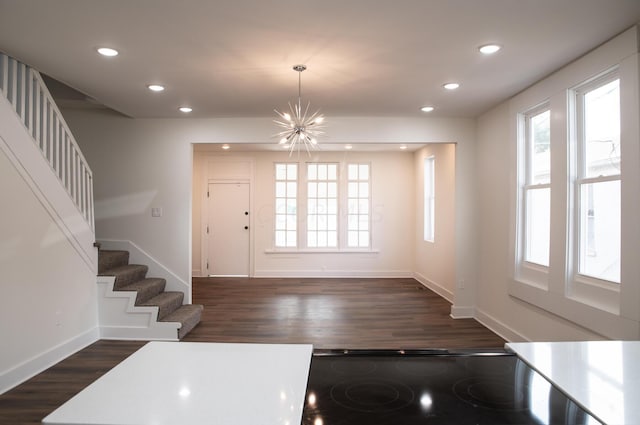 kitchen with plenty of natural light, dark hardwood / wood-style floors, and an inviting chandelier