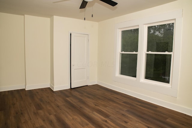 empty room featuring dark hardwood / wood-style floors and ceiling fan