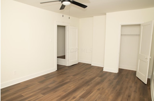 unfurnished bedroom with ceiling fan, a closet, and dark wood-type flooring