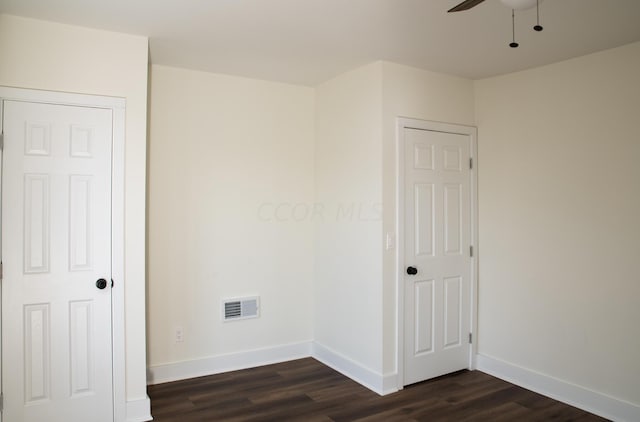 spare room featuring ceiling fan and dark hardwood / wood-style floors