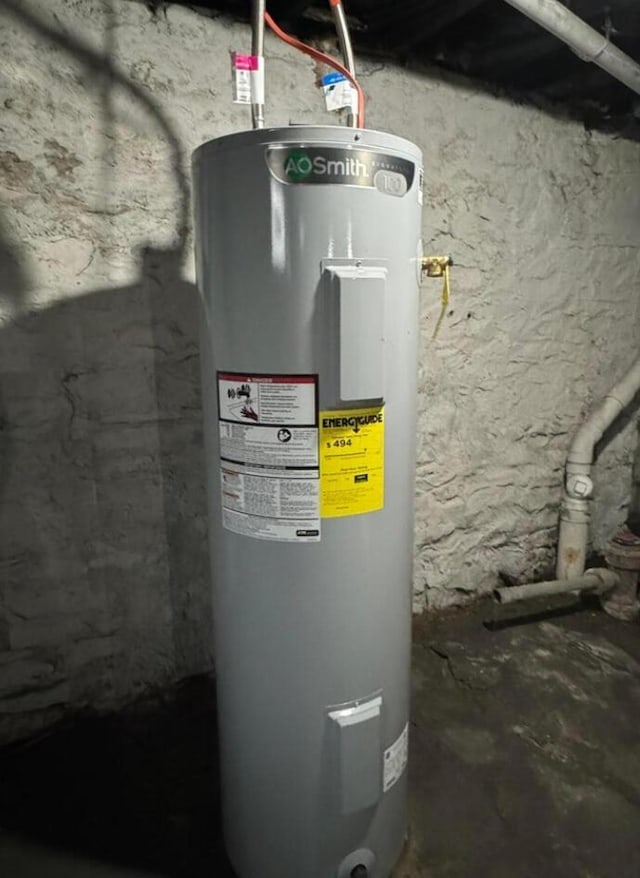 utility room featuring water heater