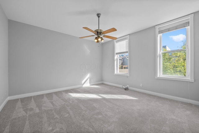 spare room featuring light carpet and ceiling fan