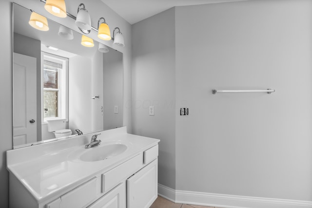 bathroom with toilet, tile patterned floors, and vanity