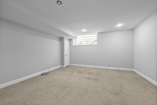 basement featuring light carpet