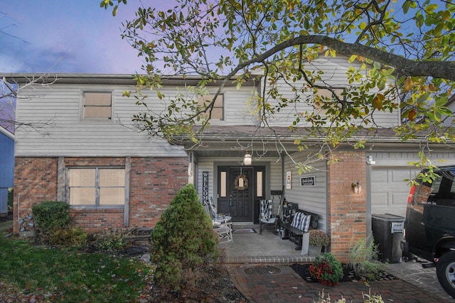 view of front of house with covered porch and a garage