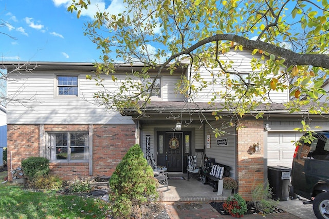 view of front of property with covered porch and a garage